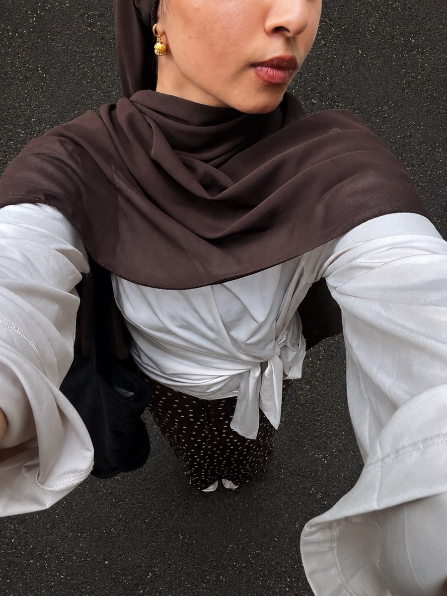 Outfit and gold earring detail